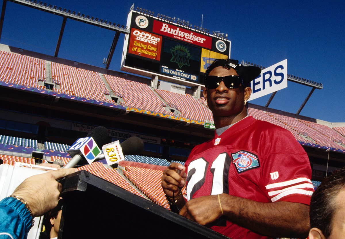 Jan 24, 1995; Miami, FL, USA; FILE PHOTO; San Francisco 49ers cornerback Deion Sanders (21) talks with media during media day prior to Super Bowl XXIX against the San Diego Chargers at Joe Robbie Stadium. The 49ers defeated the Chargers 49-26